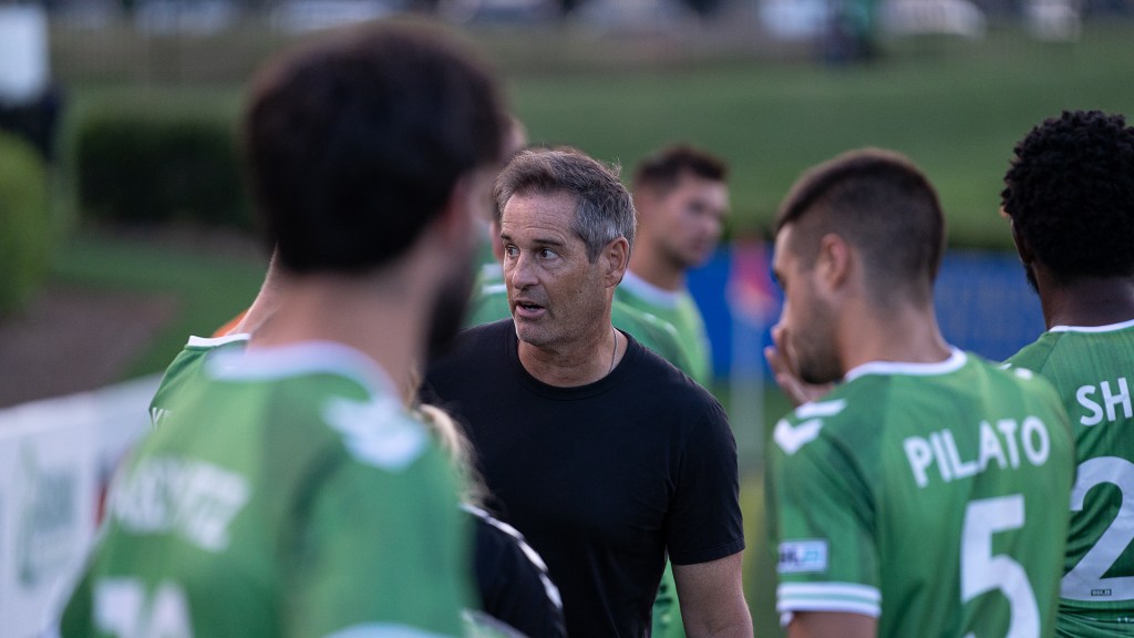 Head Coach Harkes addresses the team during halftime against NCFC.