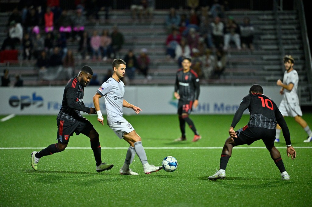 Midfielder Noah Pilato keeps possession as Greenville clinches fifth consecutive playoff berth at Chattanooga.