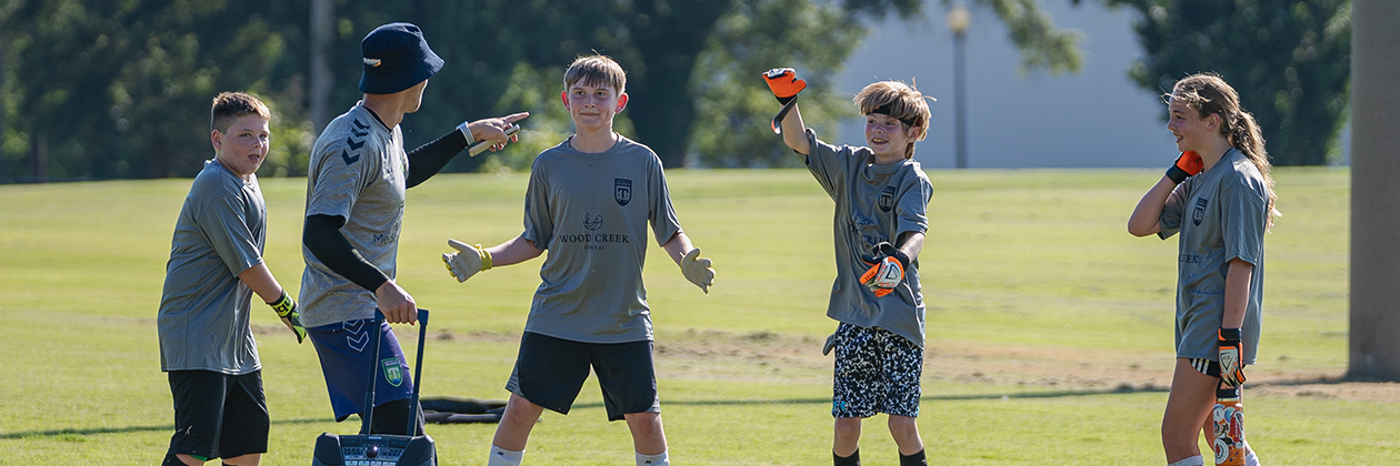 Jared Mazzola engages with players at the Greenville Triumph soccer camp.