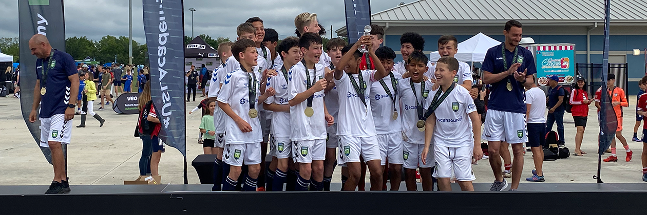 The 2022 U13 Boys team celebrates winning the division at USL Academy Cup.